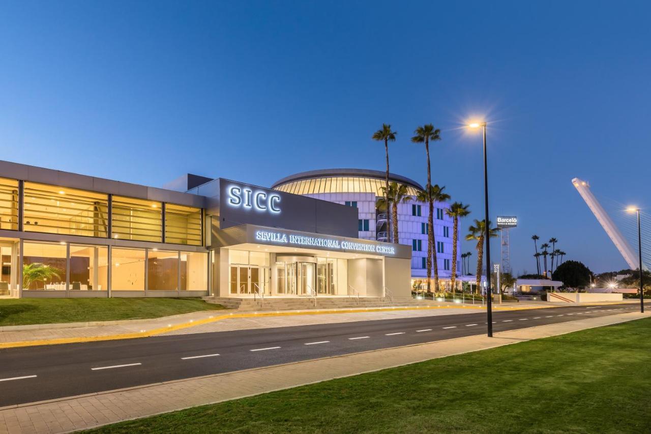 Barcelo Sevilla Renacimiento Esterno foto The image depicts a modern building with the acronym "SICC" prominently displayed on its facade. It appears to be a convention center or similar facility, characterized by a sleek, contemporary architectural design. The exterior features glass elemen